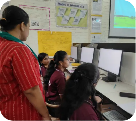 Group of students working on computers in a classroom training environment